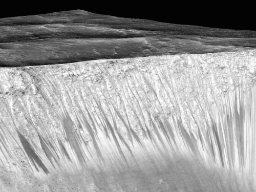 The walls of the Garni Crater on Mars have dark, narrow streaks that NASA says reveal liquid water. Terran scientists are jumping up and down with glee, but there’s a catch…