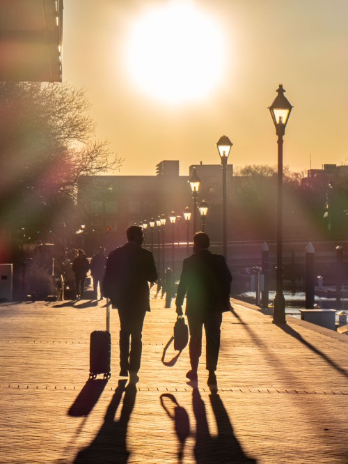 Two men walk to work in Baltimore's Harbor East neighborhood at sunrise