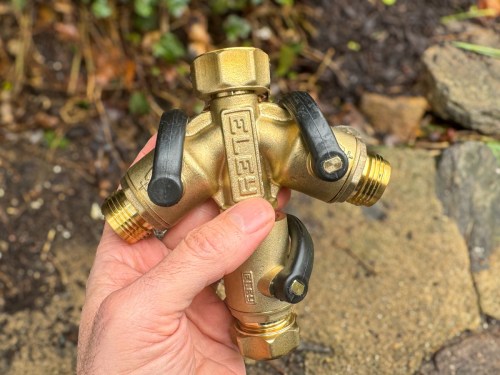 Holding ELEY lead-free brass garden hose 2-way splitter with shut off valve on bottom